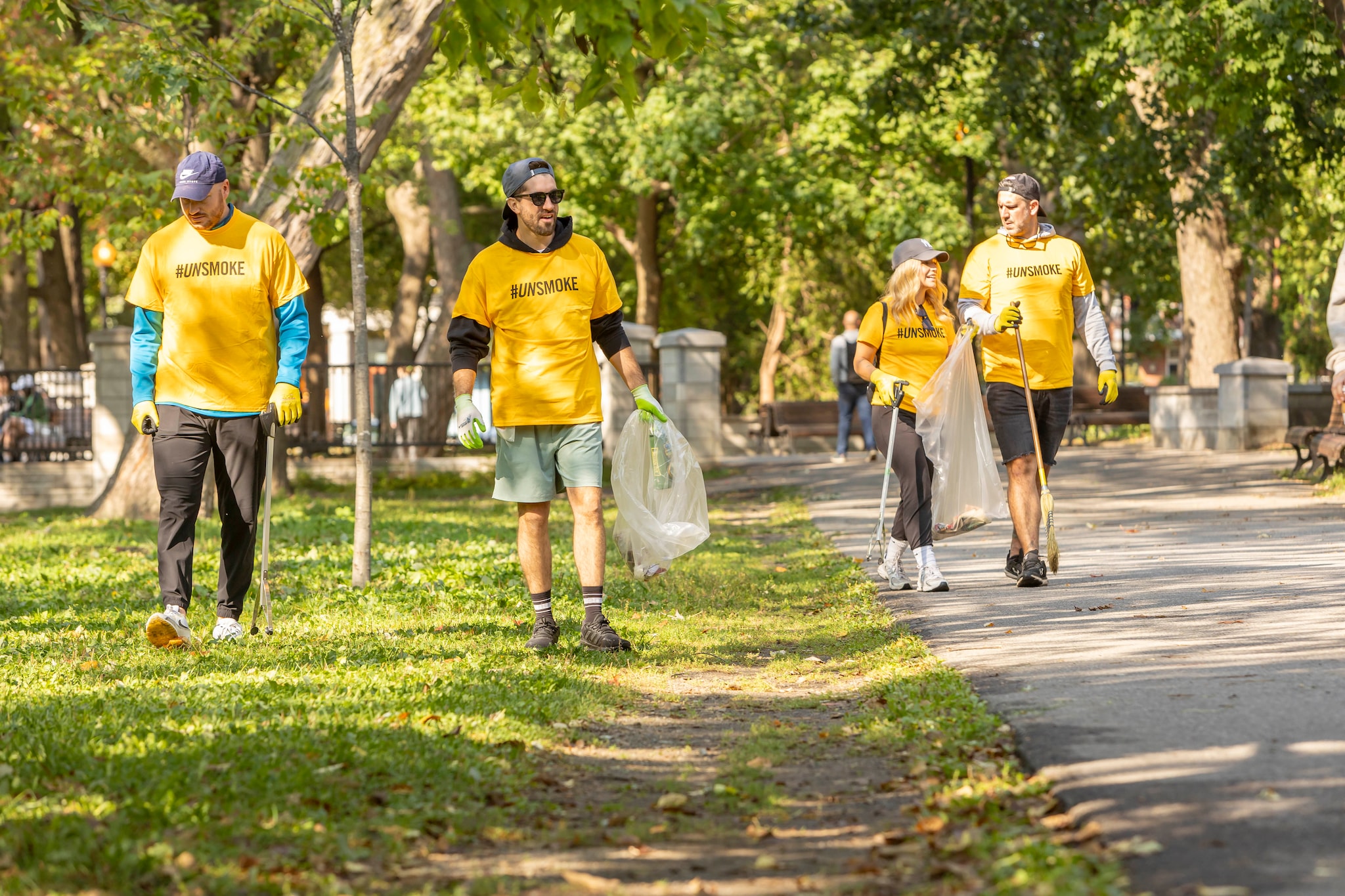a group of volunteers wearing yellow unsmoke tee shirts posing for a picture
