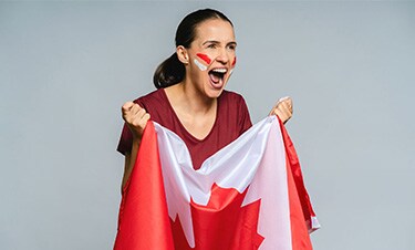 Person cheering with a Canadian flag.